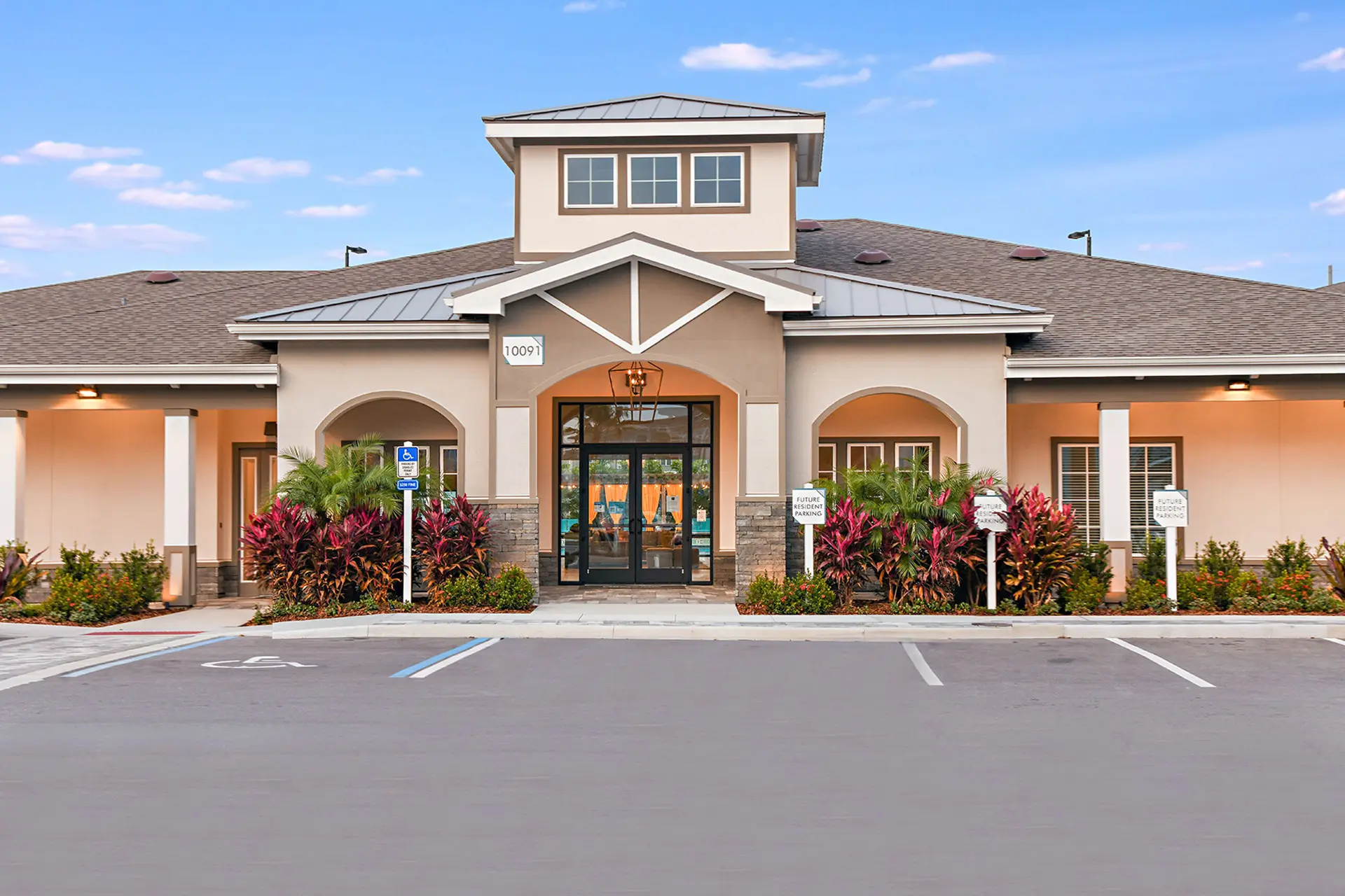 front entrance of Halston Waterleigh leasing office with view of the swimming pool cabanas through the windows.