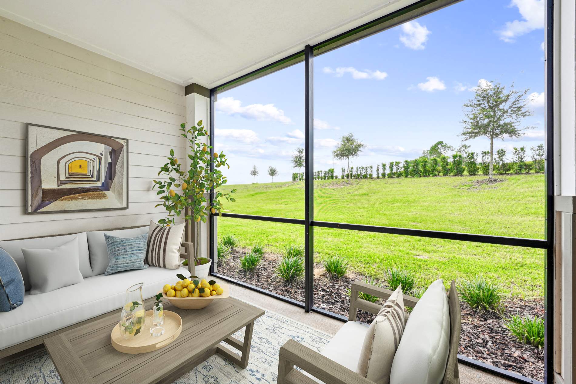 enclosed screened patio with wooden patio furniture, panel wall, wall art, beige cushions